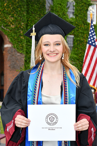 Emma Hyde holding her diploma