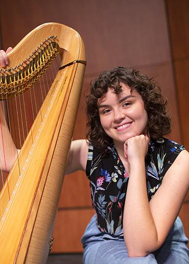 Chesty harp girl makes music for coma patients 